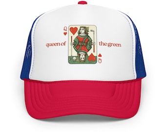 May include: A red, white, and blue trucker hat with a red brim and a white front panel. The front panel features a playing card design of the Queen of Hearts playing golf, with the text "queen of the green".