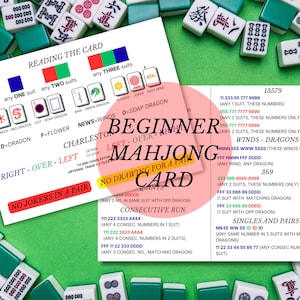 May include: A white instructional Mahjong card with black, red, green, and blue text and graphics, titled BEGINNER MAHJONG CARD. The card displays rules, suit combinations, and sequences for gameplay, surrounded by scattered white and green Mahjong tiles.