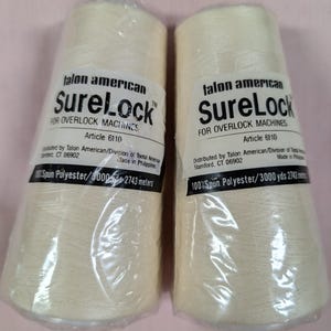 May include: Two spools of beige thread labeled "Talon American SureLock" for overlock machines. The spools are 3000 yards (2743 meters) of 100% spun polyester.