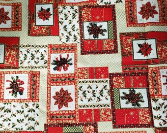 May include: A festive Christmas-themed fabric with a repeating pattern of red, white, and gold squares. Each square features poinsettias, pinecones, holly, and decorative borders. The background is a light beige color.