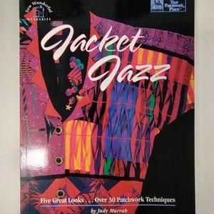 May include: A softcover book titled Jacket Jazz by Judy Murrah, featuring a colorful patchwork jacket on the cover. The design includes various fabric patterns, textures, and buttons. The text reads Five Great Looks... Over 30 Patchwork Techniques.
