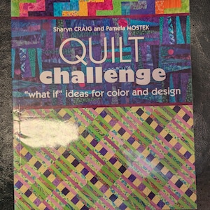 May include: A book titled "QUILT challenge" by Sharyn Craig and Pamela Mostek. The cover features a colorful patchwork design in shades of blue, green, purple, and orange. The text "what if" ideas for color and design is also visible.
