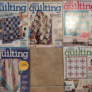May include: A collection of six "American Patchwork & Quilting" magazines. The covers feature various quilt designs, including geometric patterns and floral motifs. The magazines' titles and cover text are visible, with a focus on quilting techniques and projects.