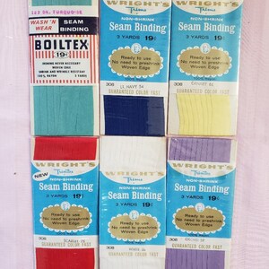 May include: Six packages of Wright's Trims non-shrink seam binding in various colors. Each package contains 3 yards of 100% rayon seam binding. The colors are turquoise, navy blue, canary yellow, scarlet red, white, and orchid.