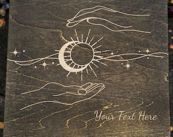 May include: A wooden box with a sun, moon, and stars design engraved on the lid. The box has a latch and is closed. The text "Your Text Here" is engraved on the lid.