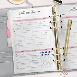 May include: A weekly wellness planner with a pink and gray color scheme. The planner includes sections for breakfast, lunch, dinner, snacks, exercise, self-care, and water. The planner is designed to help people track their daily habits and goals.