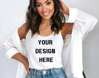 May include: White tank top with the text "YOUR DESIGN HERE" printed on the front. The model is wearing the tank top with a white button-down shirt over it.