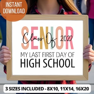 May include: A rectangular wooden frame holding a sign with the text SENIOR in large pastel letters, Class Of 2022 in black script, and MY LAST FIRST DAY OF HIGH SCHOOL in black sans-serif font. The sign includes text indicating 3 sizes included 8x10, 11x14, 16x20.