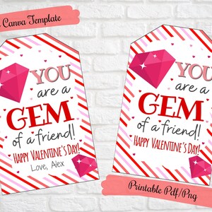 May include: Printable Valentine's Day gift tag with a red and pink striped background. The tag features a pink diamond with a white sparkle and the text "YOU are a GEM of a friend! HAPPY VALENTINE'S DAY! Love, Alex".