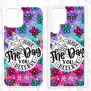 May include: Two white phone cases with a colorful floral pattern and the text "Have the day you deserve" in a circle with a skeleton hand.