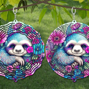 May include: Two metal wind spinners with a sloth design. The sloth is surrounded by pink and blue flowers. The spinners are hanging from a rope.