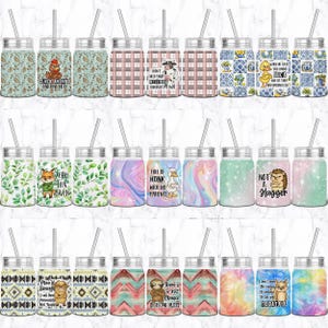 May include: A collection of mason jar tumblers with various designs and quotes. The tumblers feature stainless steel lids, clear straws, and colorful patterns, including floral, animal, and abstract designs. Some tumblers have text like "Cluck Around and Find Out" and "Not a Hugger."