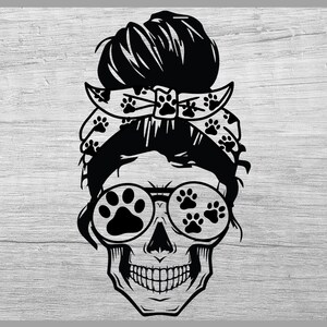 May include: Black and white illustration of a skull with a messy bun hairstyle, wearing a bandana with paw prints and sunglasses with paw print lenses.