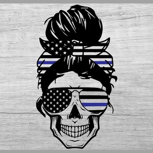 May include: Black and white skull illustration with a messy bun hairstyle, sunglasses, and a bandana featuring the American flag. The sunglasses have a blue line, and the bandana has a blue line. The background is a light grey wood grain.