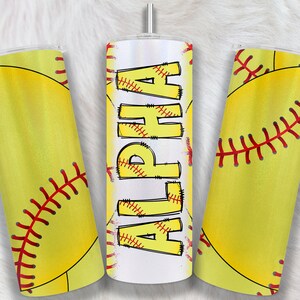 May include: Three stainless steel tumblers with a softball theme. The tumblers have a white background with a yellow softball design. One tumbler has the word "ALPHA" written in yellow letters with red stitching. The other two tumblers have a yellow softball with red stitching.