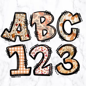 May include: Decorative fall-themed letters and numbers. The letters ABC and numbers 123 are outlined in black with decorative fall patterns inside. The patterns include floral, gingham, and pumpkin designs in orange, cream, and brown.