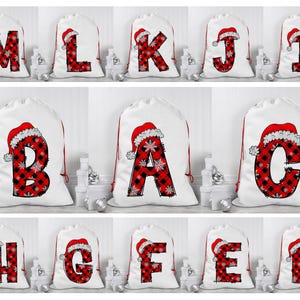 May include: Ten white Christmas gift bags with red and black plaid letters and Santa hats. The letters spell out "MERRY CHRISTMAS".