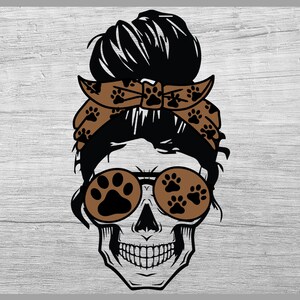 May include: A black and white skull with a brown bandana with paw prints and brown sunglasses with paw prints. The skull has a messy bun hairstyle.
