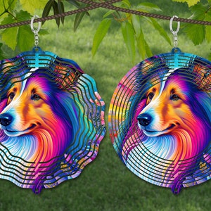 May include: A colorful metal wind spinner featuring a Collie dog's face. The spinner has a layered design with a rainbow of colors, including pink, blue, green, and yellow. The dog's face is centered in the spinner, and the background is a swirling pattern of colors.