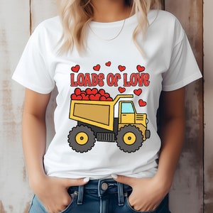 May include: White t-shirt with a yellow dump truck filled with red hearts and the text "Loads of Love".
