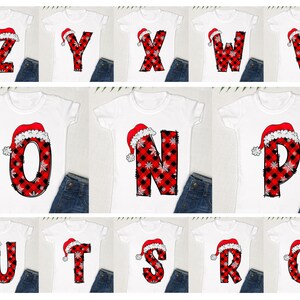 May include: Ten white t-shirts with red and black plaid letters and a Santa hat on top of each letter. The letters spell out the alphabet from Z to Q.