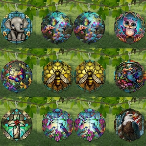 May include: Set of 12 stained glass ornaments featuring various designs, including butterflies, bees, birds, owls, and elephants. Each ornament is suspended from a silver hook and has a black wire frame.