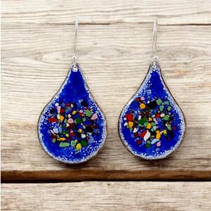 Handmade blue and multicolour vitreous enamel teardrop earrings on copper hung from sterling silver ear wires.