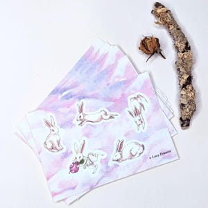 Hoja de pegatinas con bonitos conejos blancos para decoración de primavera