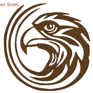 May include: A brown stylized eagle head design with a circular pattern behind it. The eagle's eye is visible and the design is outlined in black.