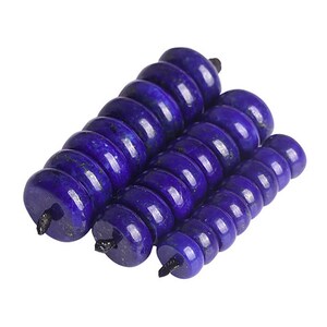 May include: A stack of dark blue lapis lazuli beads, each bead is round and has a hole in the center.