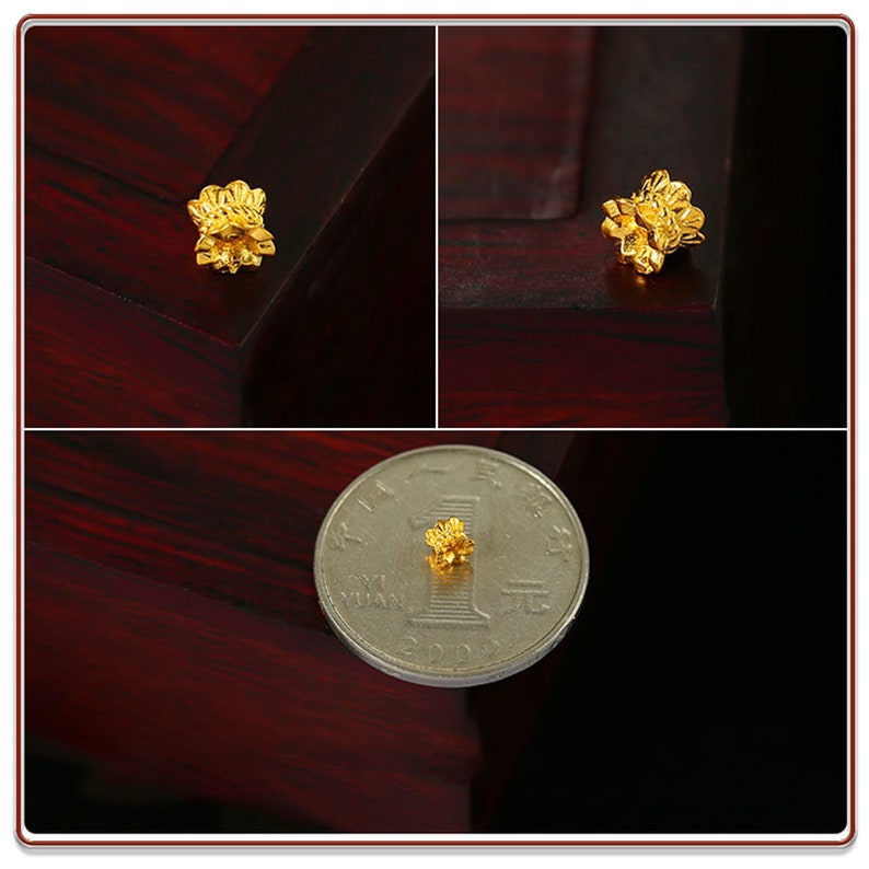May include: A small, gold-colored flower charm. The charm is about the size of a US dime.