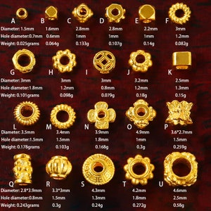 May include: A collection of 16 gold-colored metal beads with various shapes and sizes. The beads are arranged in rows on a wooden surface. Each bead has a different diameter and hole diameter, with measurements listed below each bead.