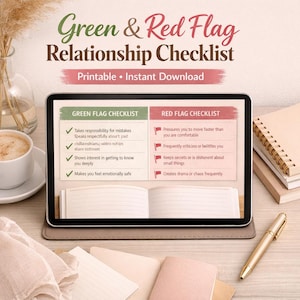 May include: A white ceramic mug with a black handle and the text "But First, Coffee" in a bold, black font. The mug is set against a blurred background, suggesting a cozy setting.