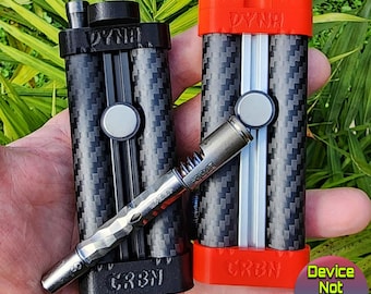 May include: Two black and red cases with a carbon fiber pattern and the words "DYNA" and "CRBN" printed on them. The cases are designed to hold a Dynavap vaporizer, but the vaporizer is not included.