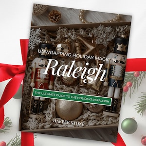 May include: A festive book cover titled "Unwrapping Holiday Magic in Raleigh" with a red ribbon and Christmas decorations. The book displays a box of ornaments and two nutcracker figures. The subtitle reads "The Ultimate Guide to the Holidays in Raleigh."