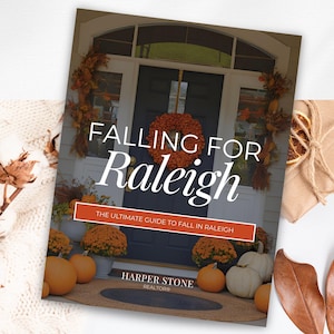 May include: A magazine cover titled "Falling for Raleigh" with a fall-themed front door scene. The cover features a wreath, pumpkins, and the text "The Ultimate Guide to Fall in Raleigh."