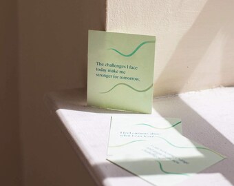 May include: Two green cards with inspirational quotes. The top card says "The challenges I face today make me stronger for tomorrow."