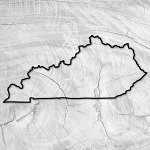 May include: A black outline of the state of Kentucky against a gray and white wood grain background. The state's borders are clearly defined, with a focus on the unique shape. The wood grain adds a natural, textured element to the design.