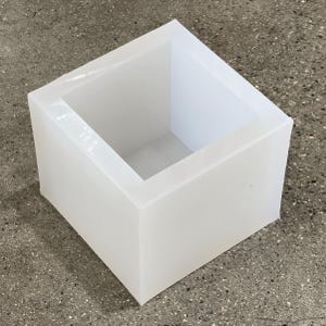 May include: A white silicone mold shaped like a square box. The mold is empty and ready to be used for making crafts or soap.