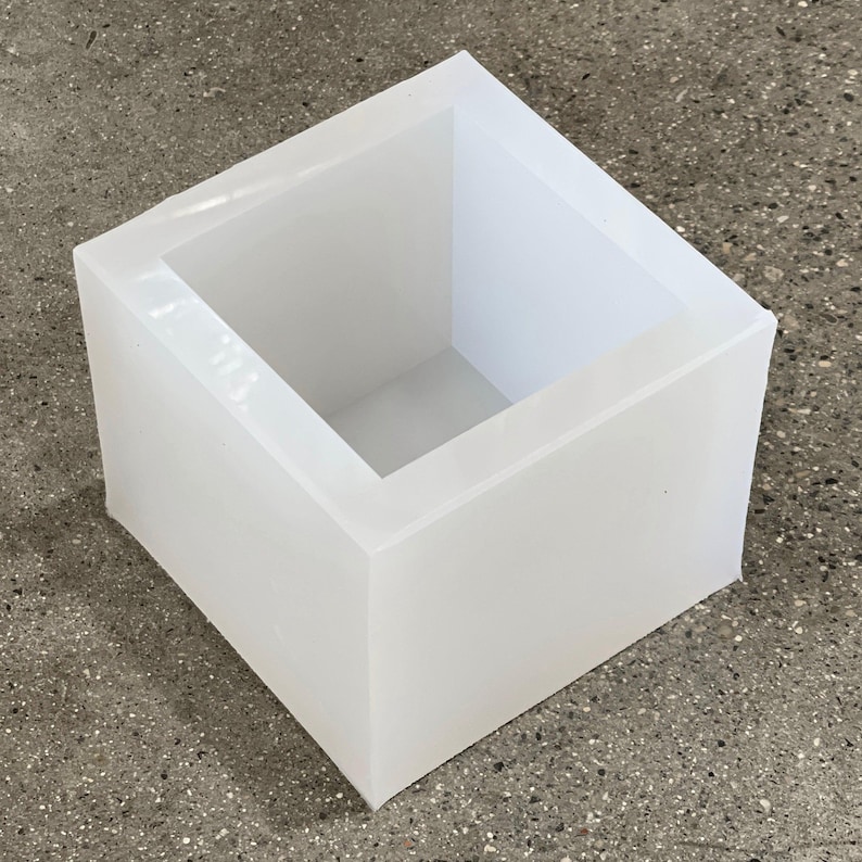 May include: A white silicone mold shaped like a square box. The mold is empty and ready to be used for making crafts or soap.