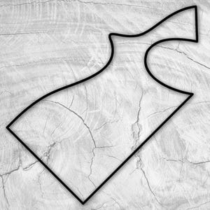 May include: A black line drawing of a racetrack on a white wood background.