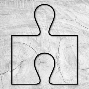 May include: A black puzzle piece with a simple design, outlined against a light gray woodgrain background.