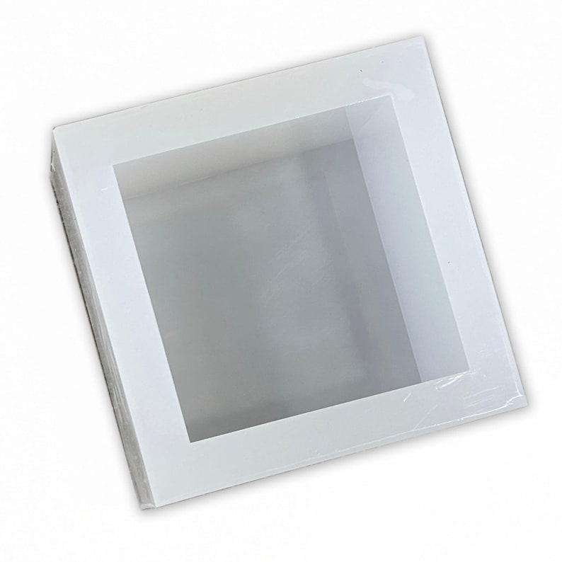 May include: White silicone mold for making square soap bars. The mold has a smooth, glossy finish and is designed to create a professional-looking soap.