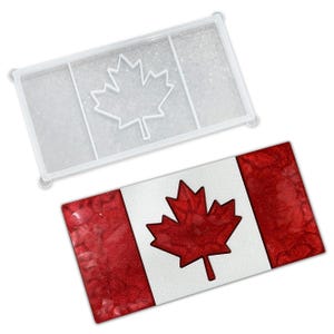 May include: A finished Canadian flag with a red maple leaf and red glitter stripes, next to a clear silicone mold with the maple leaf outline. The flag design is a patriotic symbol.