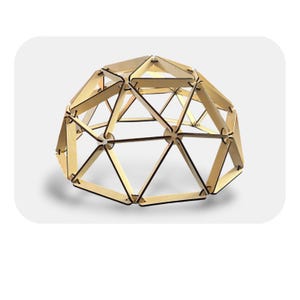 May include: A wooden geodesic dome structure. The dome is constructed from interlocking wooden pieces, forming triangular and pentagonal shapes. The wood has a light, natural color with dark brown edges, creating a geometric pattern. The dome sits on a white background.