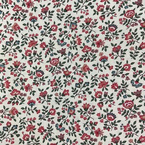 May include: A textile fabric featuring a repeating pattern of small red and pink flowers with dark green leaves and stems on an off-white background. The floral design consists of various blossoms and buds arranged in a dense, continuous botanical print.