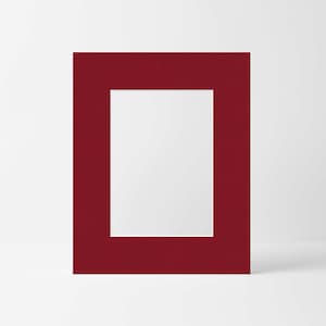 May include: A deep red mat with a white rectangular opening in the center. The mat is designed to be used for framing artwork or photographs.
