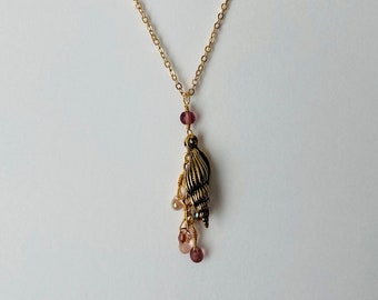 Gold or silver plated shell charm with cascading teardrop glass beads