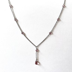 Amethyst teardrop necklace with matching purple crystal accents on delicate gunmetal chain