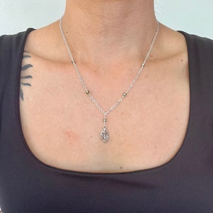 Silver leaf charm necklace with iridescent gold accented green beads